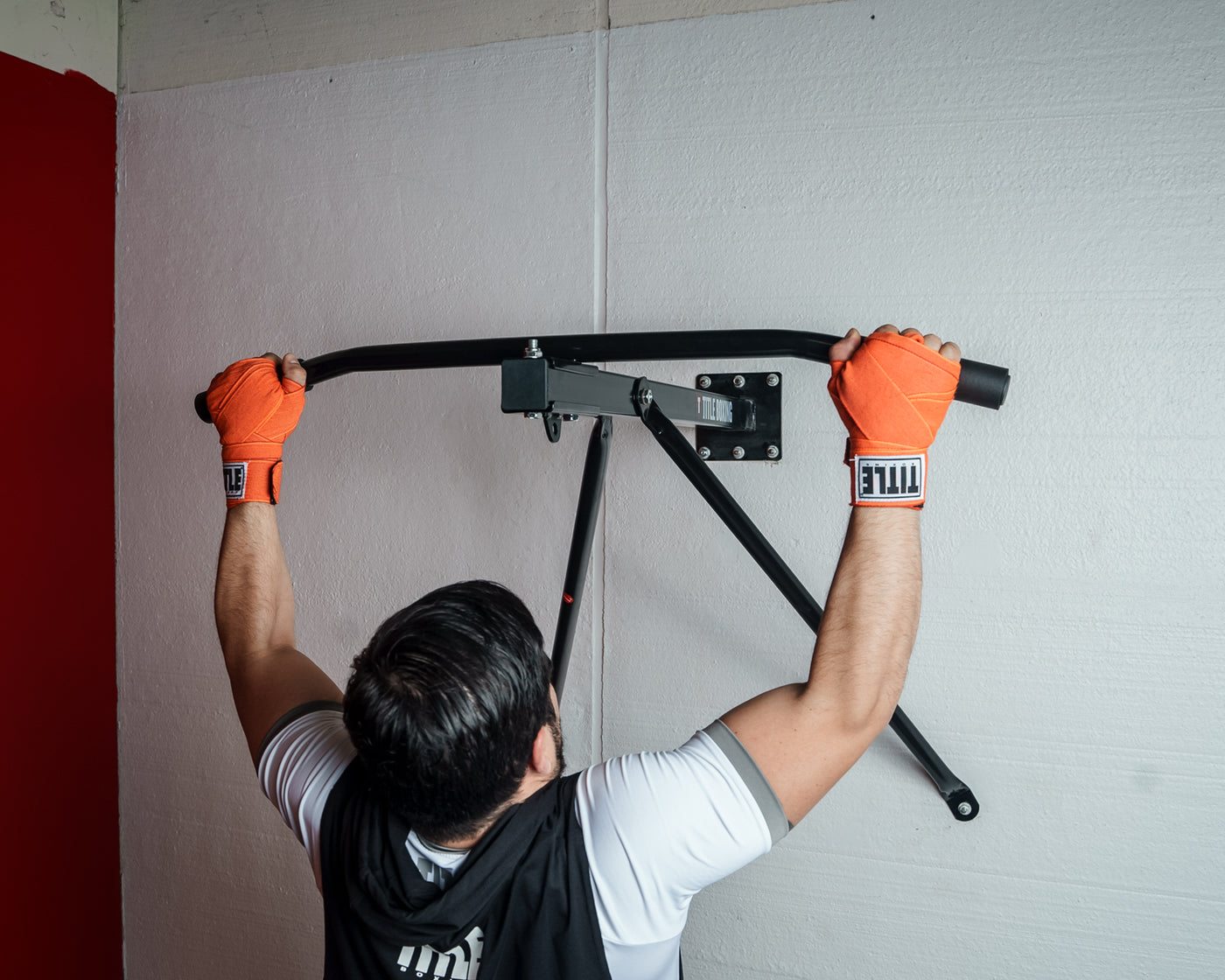 variant:lifestyle::
TITLE Boxing Deluxe Wall Mount Pull-Up Bar & Bag Hanger in use in a boxing gym