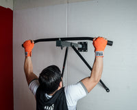 variant:lifestyle::
TITLE Boxing Deluxe Wall Mount Pull-Up Bar & Bag Hanger in use in a boxing gym