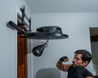 variant:lifestyle::TITLE Boxing Complete Doorway Speed Bag Platform being used by a boxer
