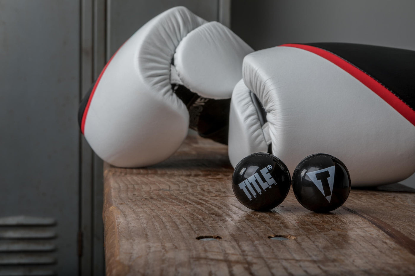 variant:lifestyle::TITLE Boxing Equipment Deodorizer Balls in front of a pair of boxing gloves