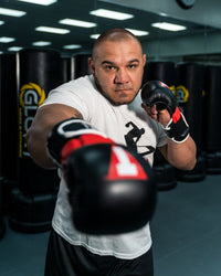 variant:lifestyle::TITLE MMA Full Contact Sparring Gloves guy throwing a jab