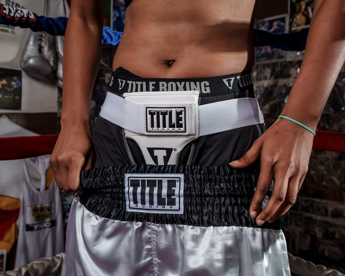variant:lifestyle::TITLE Boxing Female Groin Protector 2.0 woman wearing groin protector and trunks