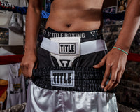 variant:lifestyle::TITLE Boxing Female Groin Protector 2.0 woman wearing groin protector and trunks