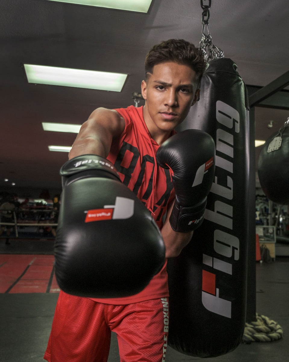 variant:black::Fighting Leather Heavy Bag Gloves guy posing with gloves
