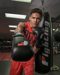 variant:black::Fighting Leather Heavy Bag Gloves guy posing with gloves