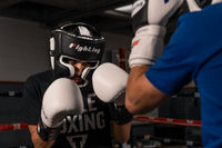 variant:Black/White::Fighting S2 GEL Power Full Training Headgear man posing in headgear
