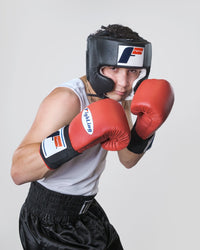 variant:Black::Fighting USA Boxing Competition Headgear with Cheeks boy posing in headgear