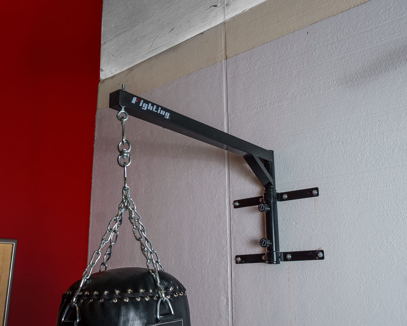 variant:lifestyle::Fighting Slip-N-Move Wallmount Hanger 2.0 in use with a heavy bag
