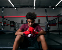 variant:red/blue::Fighting 180” Semi Elastic Hand Wrap putting on wraps