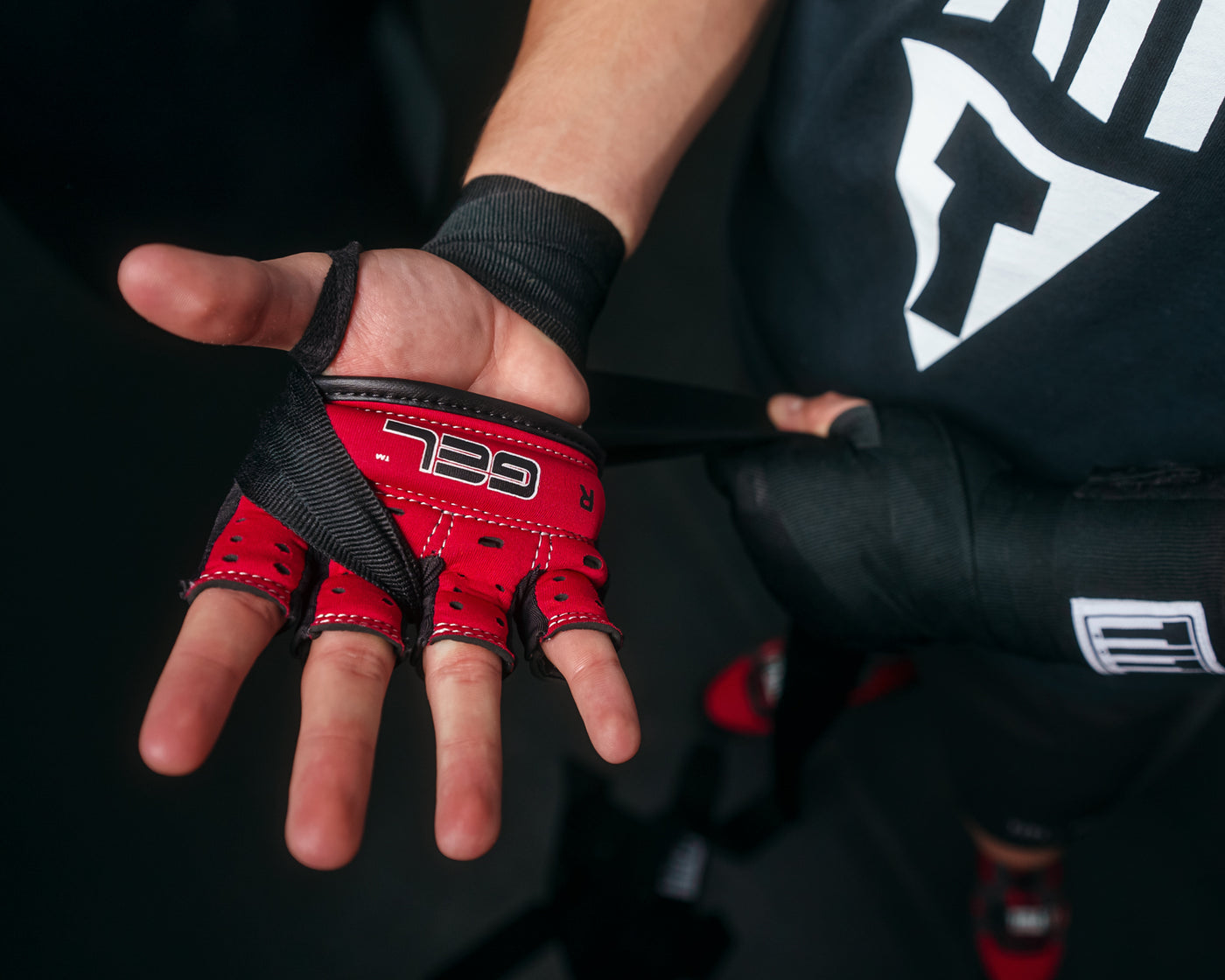 variant:lifestyle::TITLE Boxing Gel Iron Fist Slip-On Knuckle Shields 2.0 man showing bottom of shields