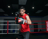 variant:Black/White/Red::TITLE Boxing Gel Weighted Boxing Gloves person posing with boxing gloves in gym
