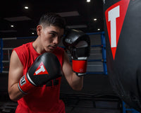 variant:Black/White/Red::TITLE Boxing Gel Weighted Boxing Gloves person wearing boxing gloves in gym