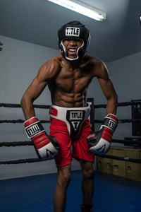 variant:Black::TITLE Boxing Gel World Full Face Training Headgear man posing with headgear