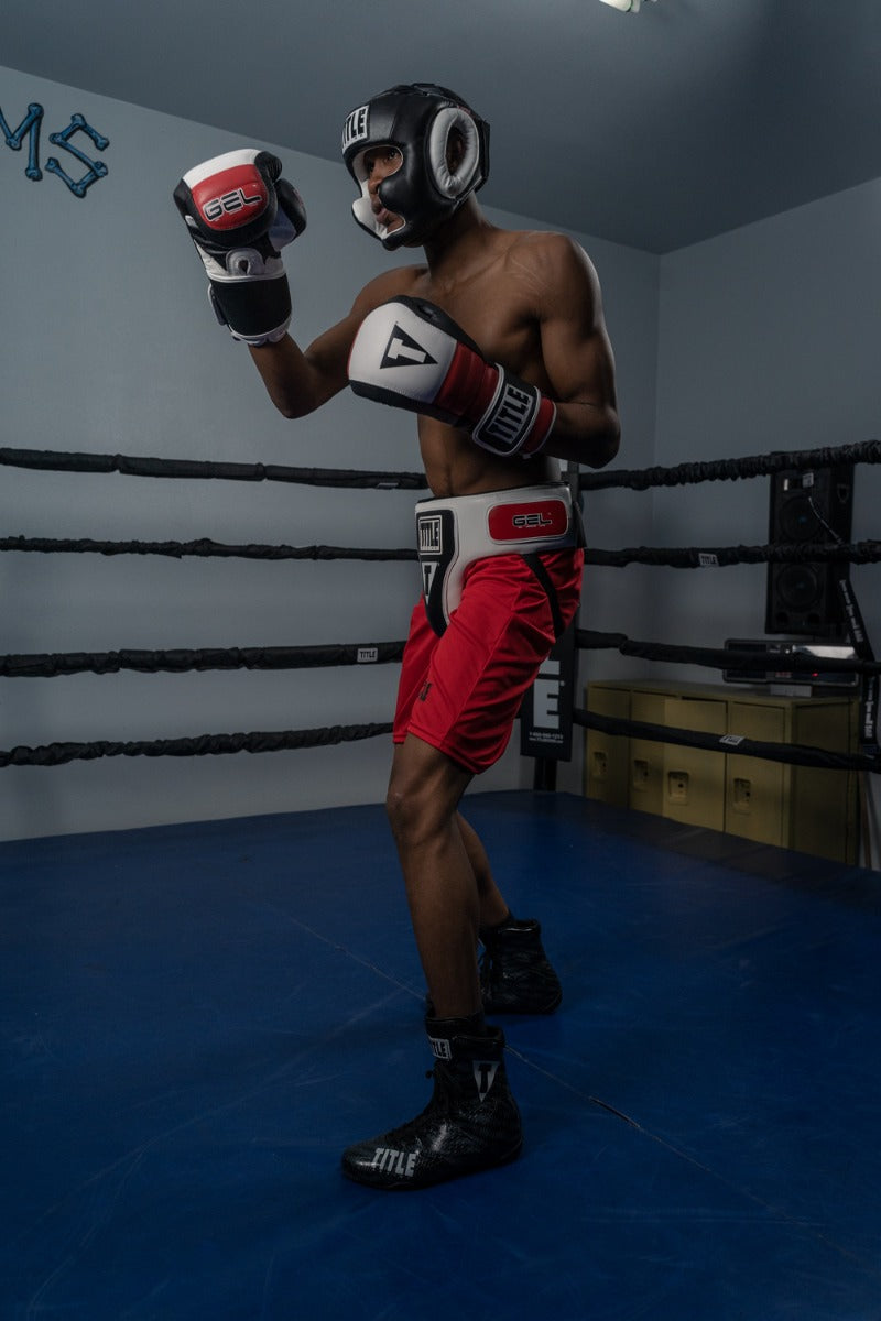 variant:Black::TITLE Boxing Gel World Full Face Training Headgear man posing with headgear