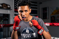 variant:Black/Grey::TITLE Boxing Gel Triple-Shox Mouth Guard 2.0 man posing with mouth guard