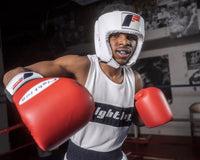 variant:Black/Grey::TITLE Boxing Gel Triple-Shox Mouth Guard 2.0 man posing with mouth guard