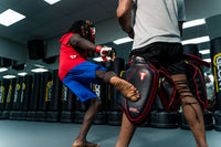 variant:lifestyle::TITLE MMA Gel Thai Style Thigh Pads 2.0 guy kicking pads