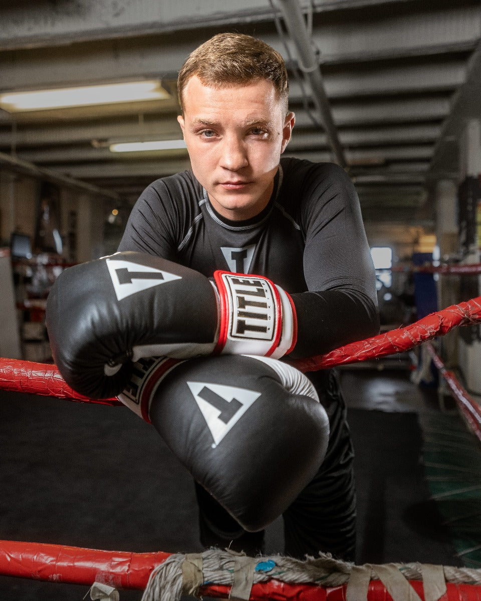 variant:Black::TITLE Boxing Gel World Bag Gloves man posing with gloves