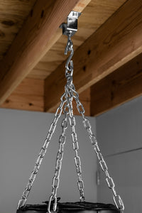 variant:lifestyle::TITLE Boxing Wooden Beam Heavy Bag T-Swivel on a beam with a heavy bag attached