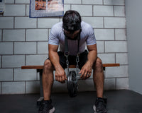 variant:lifestyle::TITLE Boxing Nylon Head Harness 2.0 man wearing harness with weight attached