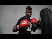 variant:lifestyle::TITLE Classic Power Weight Bag Gloves guy standing infront of bags