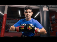 variant:Black/White/Red::BOOM BOOM Boxing Silencer Youth Bag Gloves kid standing infront of heavy bag in background