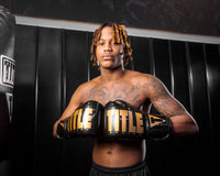 variant:Black/Gold::TITLE Boxing Inferno Intensity Elastic Training Gloves man posing in gloves