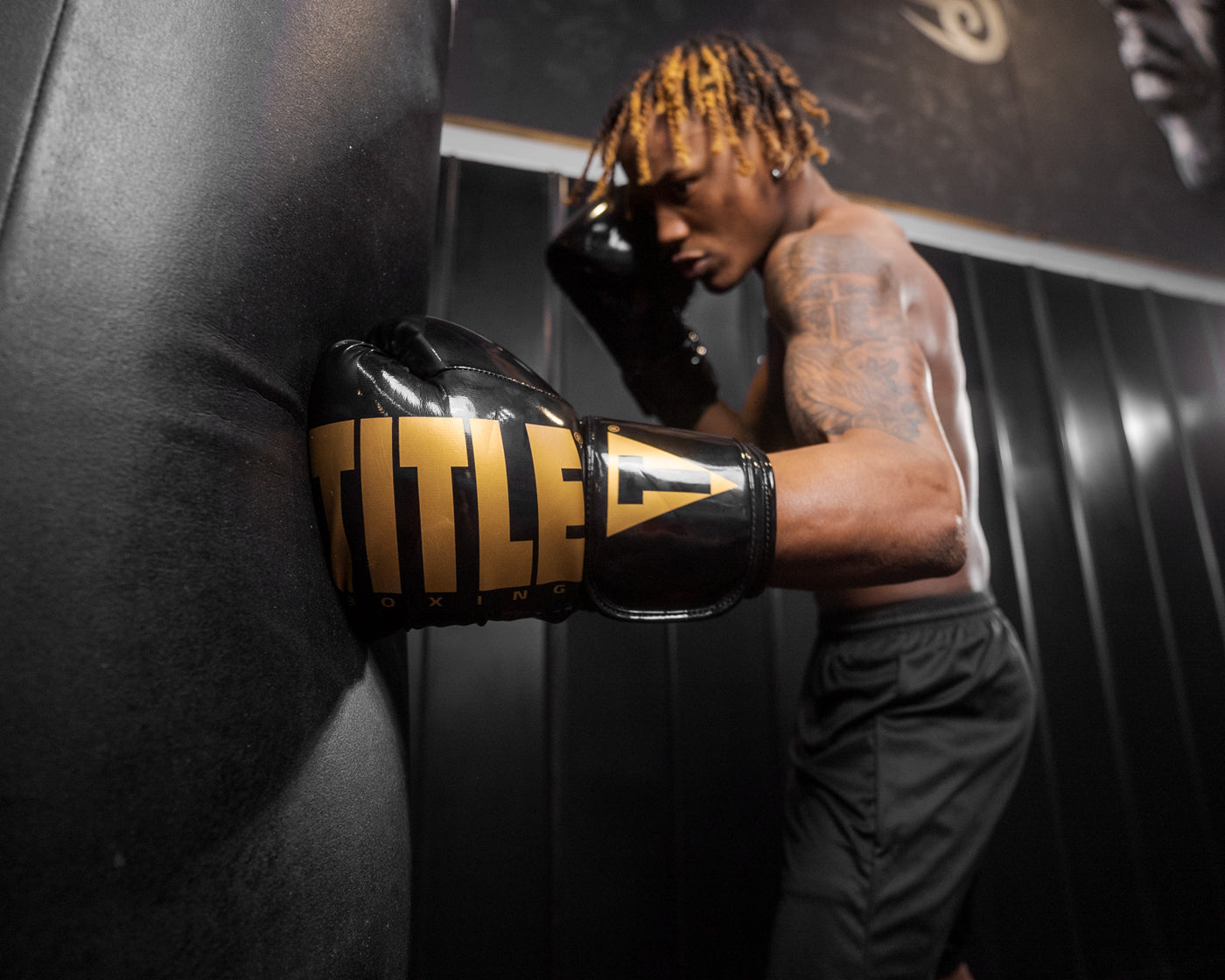 variant:Black/Gold::TITLE Boxing Inferno Intensity Elastic Training Gloves man punching bag