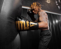 variant:Black/Gold::TITLE Boxing Inferno Intensity Elastic Training Gloves man punching bag