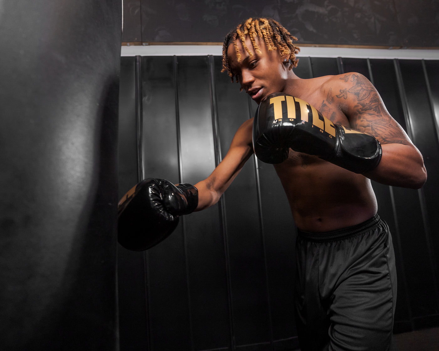 variant:Black/Gold::TITLE Boxing Inferno Intensity Elastic Training Gloves man boxing with bag