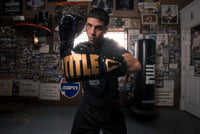 variant:Black/Gold::TITLE Boxing Inferno Intensity Lace Training Gloves left hook