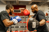 variant:lifestyle::TITLE Boxing "Double-Stuff" Jumbo Punch Mitts two guys boxing in boxing ring with punch mitts and boxing gloves