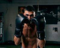 variant:black::TITLE Boxing Ko-Vert Bag Gloves guy posing wearing boxing gloves