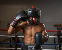 variant:Black::TITLE Boxing Ko-Vert Headgear  man posing in headgear