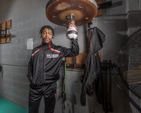 variant:lifestyle::TITLE Boxing Lightning Fast Speed Bag guy holding bag