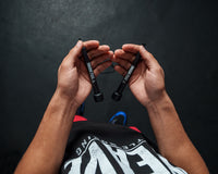 variant:lifestyle::TITLE Boxing Licorice Speed Rope 2.0 guy holding jump rope handles