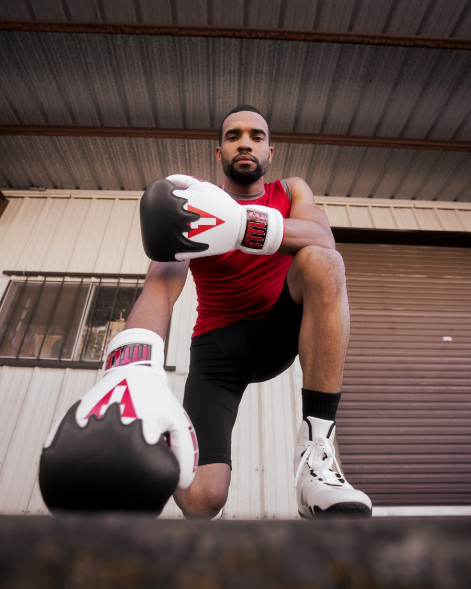 variant:white/red::TITLE Boxing Gel Lava Leather Series Sparring Gloves guy kneeling on ground