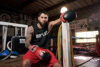 variant:Red/Black/White::TITLE Boxing Gel Lava Leather Series Training Gloves guy sitting by ring