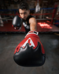 variant:Red/Black/White::TITLE Boxing Gel Lava Leather Series Training Gloves close up of jab with glove