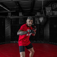 variant:lifestyle::TITLE MMA Blank Cage Bumper Pad in a boxing ring