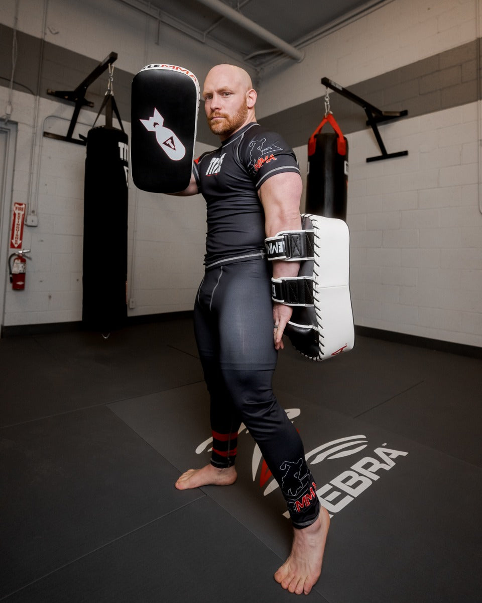 variant:black/white/grey::TITLE MMA Air Raid Thai Pads (Pair) guy in standing pose