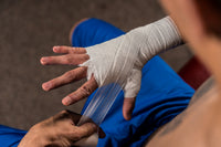 variant:lifestyle::TITLE Boxing Old School Super Gauze (50 Rolls) on a boxer's hands