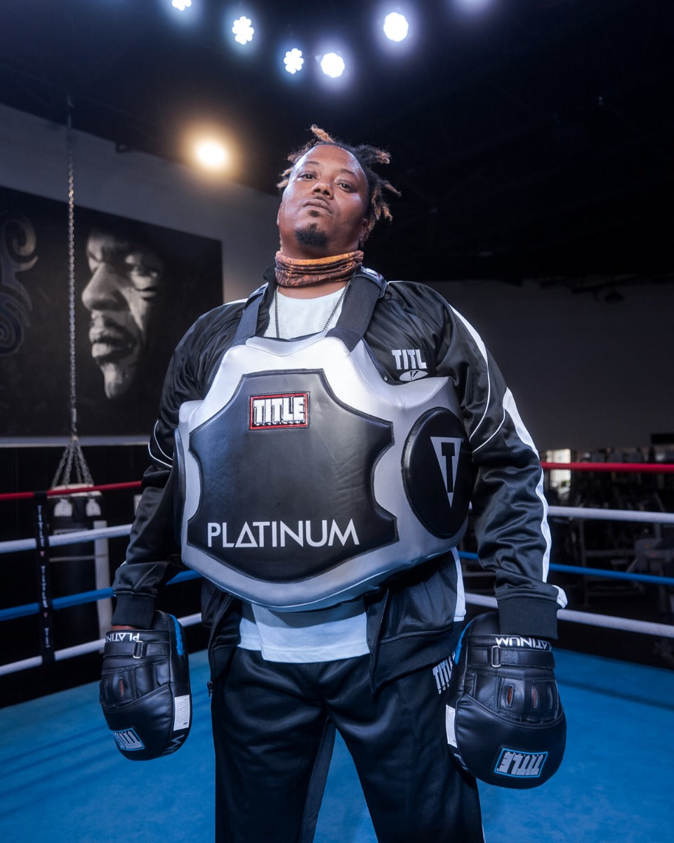 variant:lifestyle::TITLE Platinum Body Protector guy in ring with mitts on