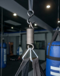 variant:lifestyle::TITLE Boxing Professional Heavy Bag Spring (Up To 250 lbs) in use in a boxing gym