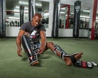 variant:lifestyle::TITLE MMA Perform World Pro Shin Guards 2.0 man putting on guards