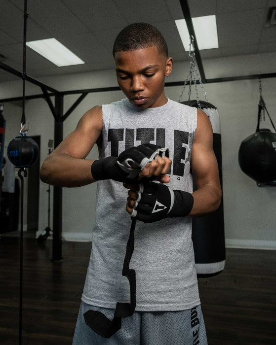 variant:lifestyle::TITLE Platinum Prime Gel Fist Wraps 2.0 boy putting on