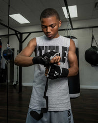 variant:lifestyle::TITLE Platinum Prime Gel Fist Wraps 2.0 boy putting on