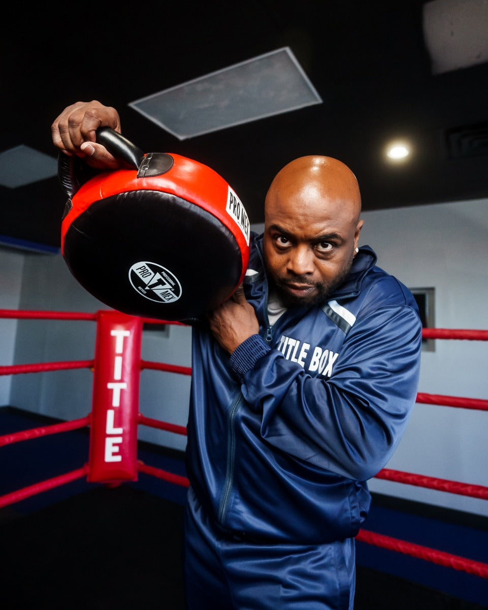 variant:lifestyle::Pro Mex Accuarcy Pro Punch Shield 2.0 coach holding up punch shield