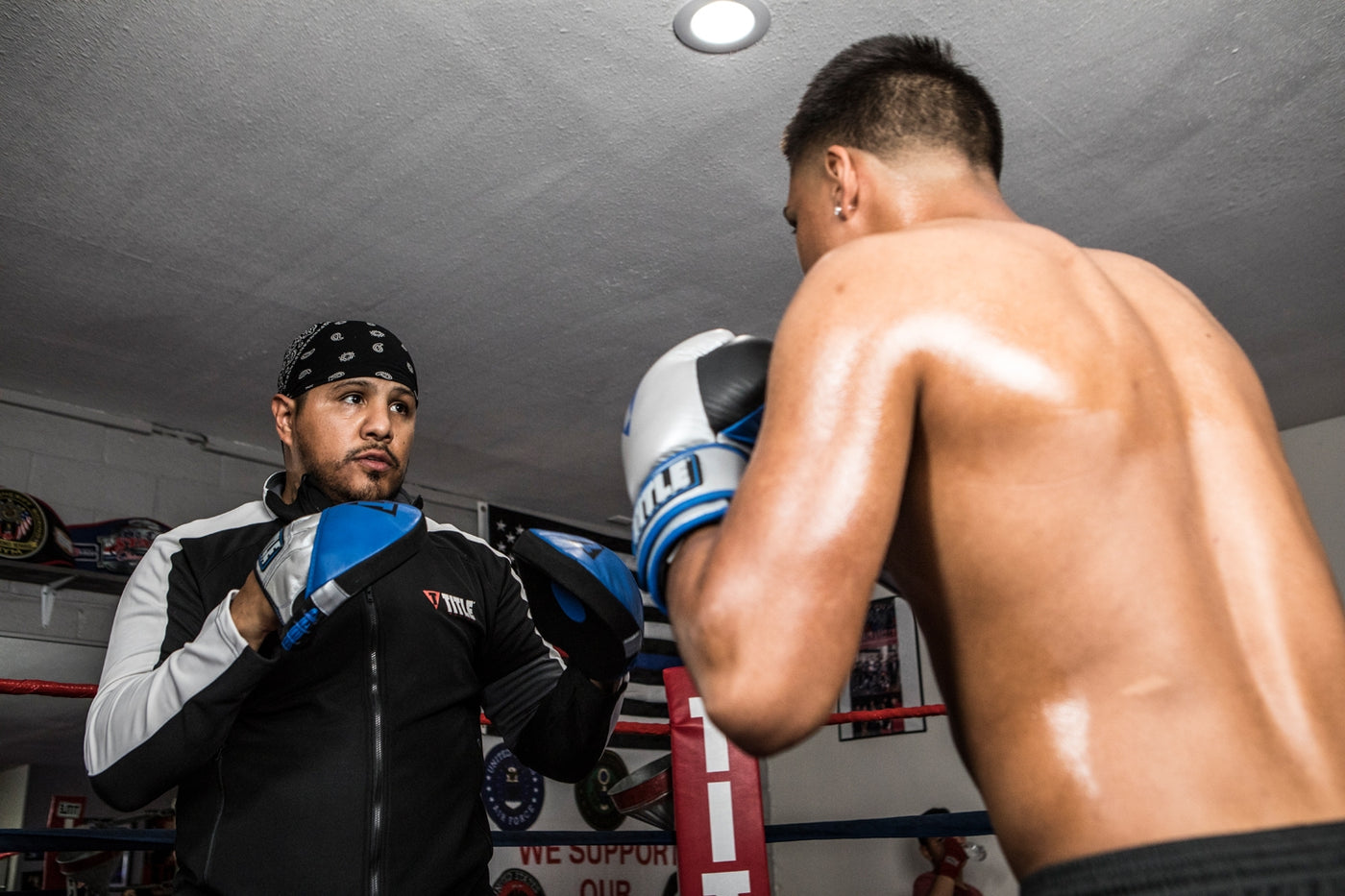 variant:lifestyle::TITLE Platinum Perilous Micro Palm Mitts two guys boxing training with mitts and gloves
