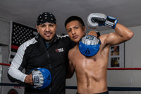 variant:lifestyle::TITLE Platinum Perilous Micro Palm Mitts second view two guys posing with punch mitts and boxing gloves